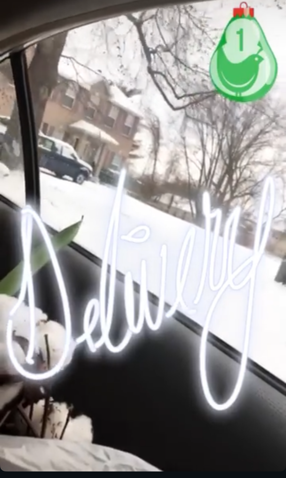 Delivery neon sign reflected in a car window with snow outside, SoapLife360 local delivery