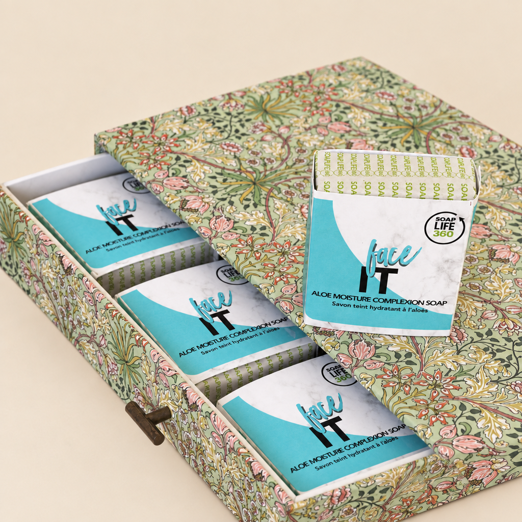 A boxed set of Face IT Aloe Moisture Complexion Soap bars, with one soap bar standing upright in front of a floral-patterned gift box.